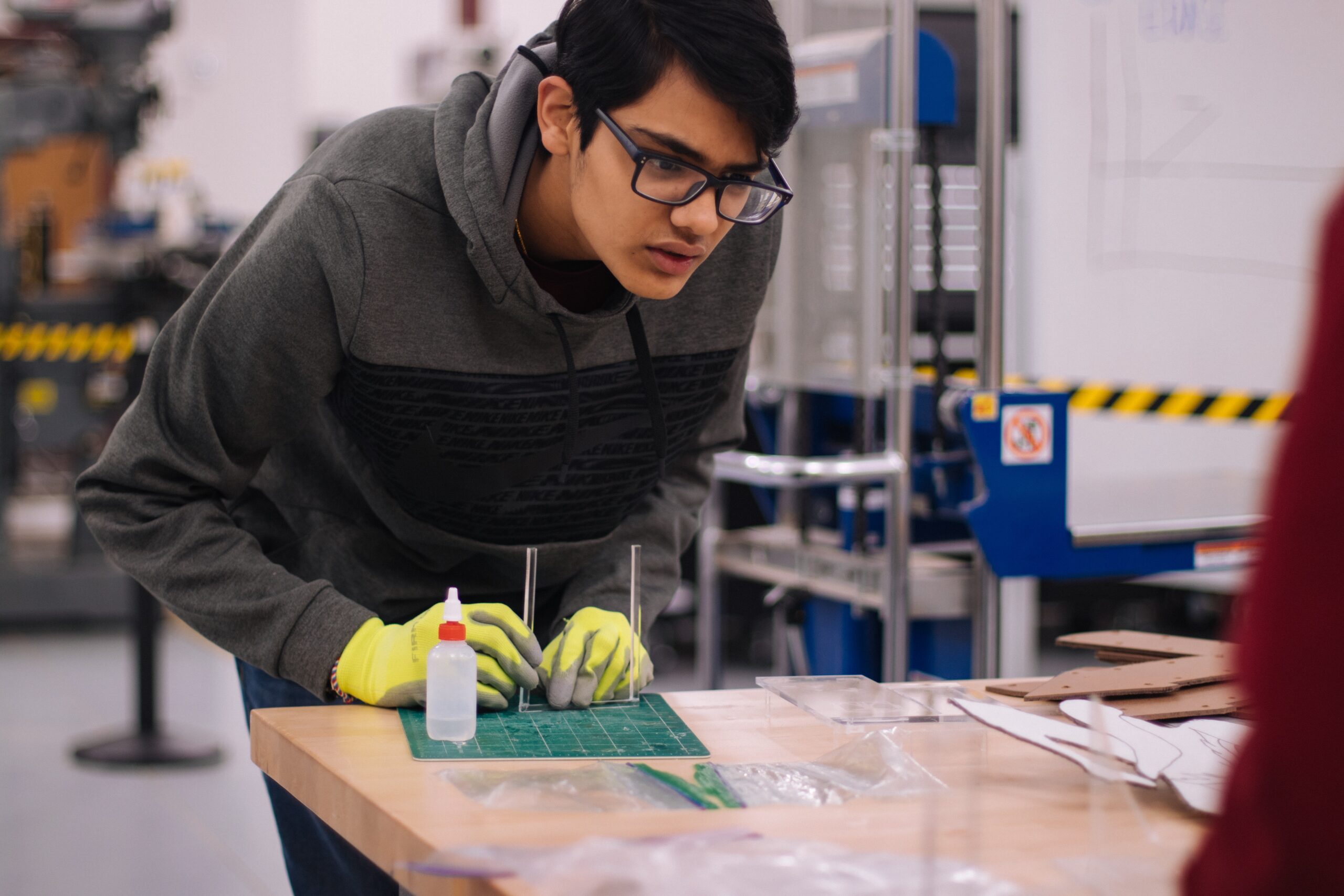 Person in gray hoodie working in a school lab