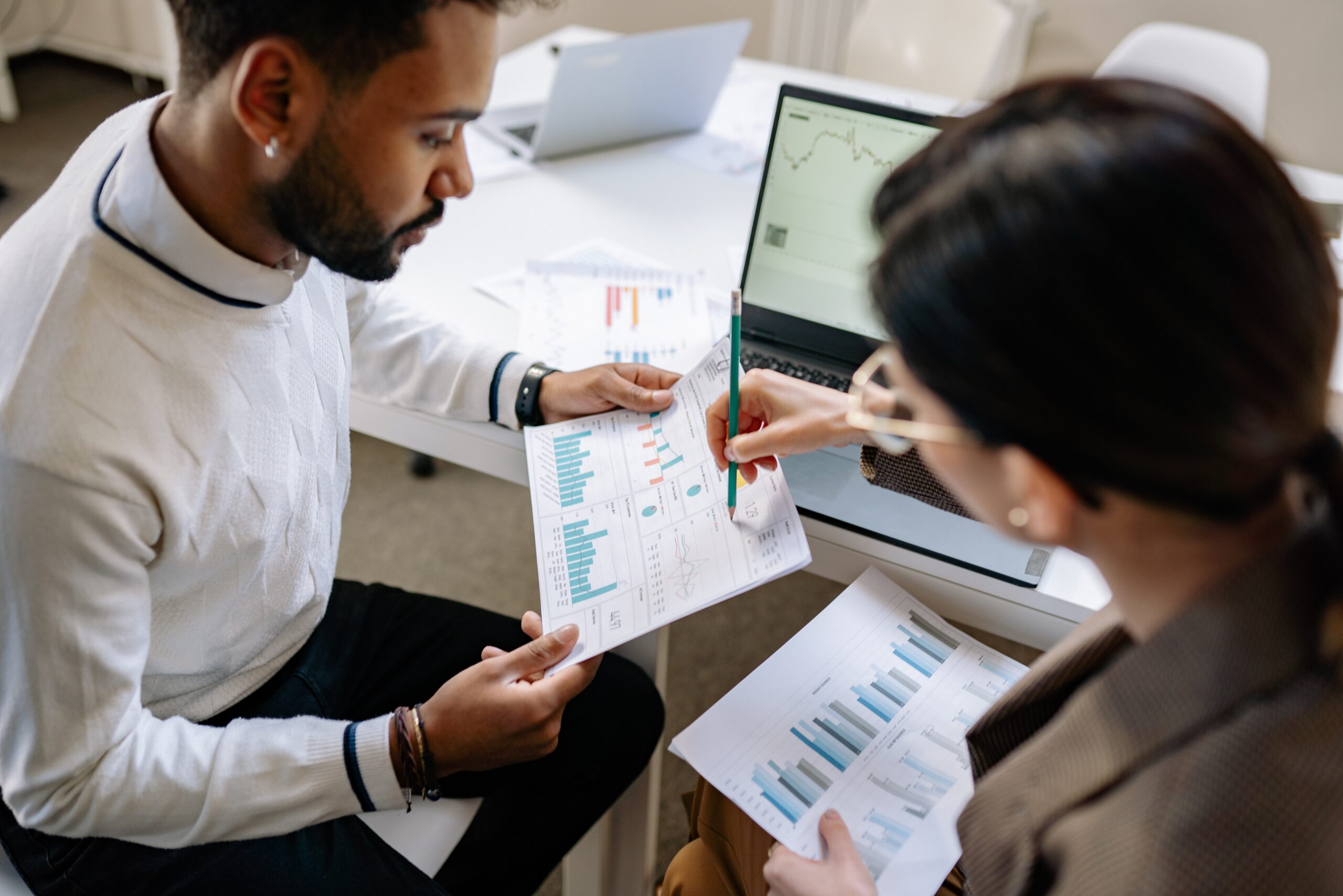 Two people going through graphical data